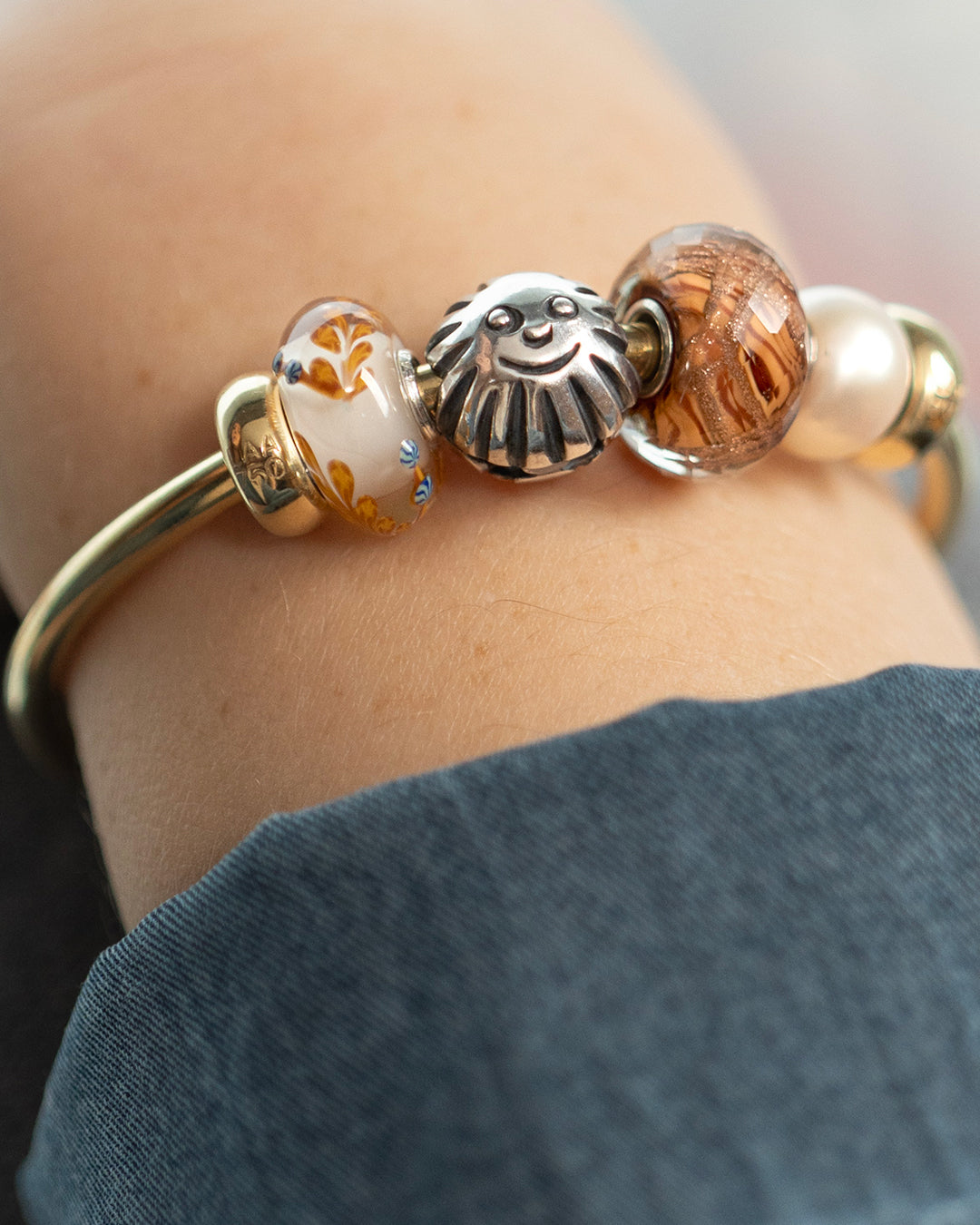 Enchanted Sun bead paired with other beads on a bangle with spacers